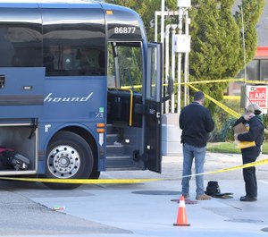 Investigators are seen outside of a Greyhound bus after a passenger was killed on board on Monday, Feb. 3, 2020 in Lebec, Calif. A gunman killed one passenger and wounded multiple others on a Greyhound bus traveling from Los Angeles to the San Francisco Bay Area early Monday morning, the California Highway Patrol said. (AP Photo/Jayne Kamin-Oncea)