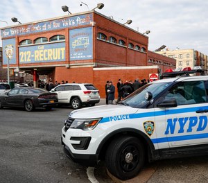 New York City police officers work the scene of a police involved shooting outside the 41st precinct Sunday, Feb. 9, 2020, in New York.