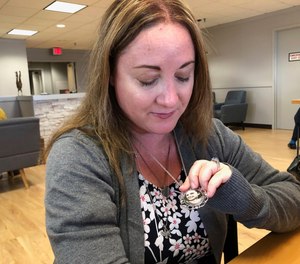 Lori Alhadeff shows a pendant bearing a photo of her 14-year-old daughter Alyssa, one of 17 killed during the 2018 shooting at Marjory Stoneman Douglas High School. Alhadeff has championed the passage of 