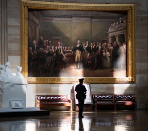 Normally filled with tourists, the empty Capitol Rotunda is patrolled by a lone U.S. Capitol Police officer after being shut down to tourists and non-essential visitors due to the coronavirus outbreak, in Washington, Friday, March 13, 2020.