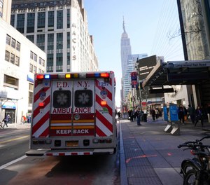 FDNY paramedics place an empty collapsible wheeled stretcher into an ambulance after delivering a patient into the emergency room at NewYork-Presbyterian Lower Manhattan Hospital.