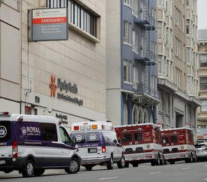 Ambulances park in front of Saint Francis Memorial Hospital on Wednesday, March 18, 2020, in San Francisco. The NHTSA's Office of EMS will be hosting a webinar with an expert panel on Thursday to discuss prehospital crisis standards of care during the COVID-19 pandemic.