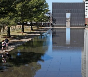 In this March 18, 2020 file photo, visitors walk next to the reflecting pool at the Oklahoma City National Memorial and Museum in Oklahoma City.