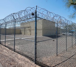 This Saturday, March 21, 2020 file photo shows barbed wire fences at the Maricopa County Estrella Jail in Phoenix. At jails across Arizona, visitation has been suspended, jail workers are checking to see if people being booked are showing symptoms of COVID-19 and inventories have been taken of gloves, masks and other supplies in March 2020.
