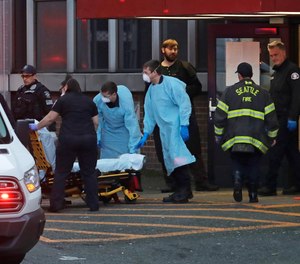 Police, fire and EMS personnel respond to a medical call in Seattle, Tuesday, March 24, 2020.