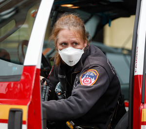 An FDNY medical worker wears personal protective equipment outside a COVID-19 testing site at Elmhurst Hospital Center, Wednesday, March 25, 2020, in New York.
