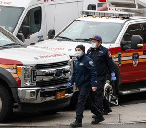 FDNY EMS providers wear personal protective equipment outside a COVID-19 testing site at Elmhurst Hospital Center, Wednesday, March 25, 2020. The FDNY confirmed Wednesday that 84 members of the department have now tested positive for COVID-19, nearly twice the amount confirmed as of Tuesday.
