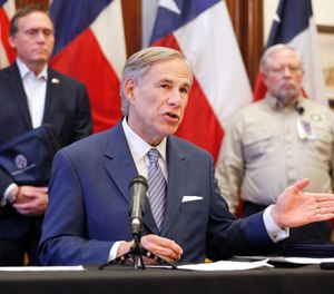 This photo shows Texas Gov. Greg Abbott announcing the building of a 250-bed hospital during a press conference at the Texas State Capitol in Austin, Sunday, March 29, 2020. Abbott is suspending some EMS certification, testing and licensure requirements in order to increase the state's EMS workforce during the COVID-19 crisis.
