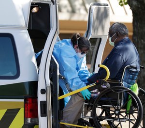A resident at the Southeast Nursing and Rehabilitation Center is loaded into an ambulance in San Antonio, Wednesday, April 1, 2020.