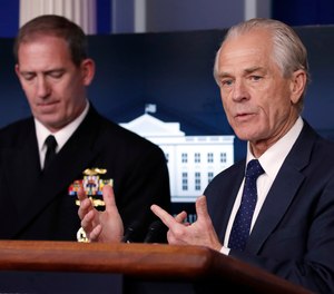 White House trade adviser Peter Navarro, who is now serving as national defense production act policy coordinator, speaks about COVID-19 in the James Brady Press Briefing Room of the White House, Thursday, April 2, 2020, in Washington, as Navy Rear Adm. John Polowczyk, supply chain task force lead at FEMA, listens. The Department of Defense announced its first use of the Defense Production Act to boost N95 production on Saturday, April 11.
