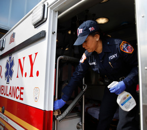 FDNY paramedic Elizabeth Bonilla strictly disinfects her ambulance prior to a double shift at EMS Station 3, Wednesday, April 15, 2020, in the Bronx borough of New York.