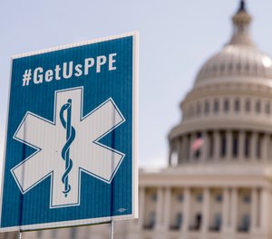 Advocacy groups displayed signs that read #GetUsPPE on the West Lawn of the U.S. Capitol, Friday, April 17, 2020, in Washington. The NAEMT has announced a