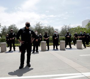 Members of the Los Angeles Police Department thank hospital workers after an officer was treated and recovered from COVID-19, Friday, April 17, 2020, outside Providence St. John's Medical Center in Santa Monica, Calif.