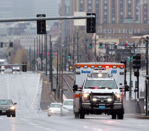 A ambulance on a call drives on Commonwealth, Ave., Friday, April 24, 2020, in Boston.