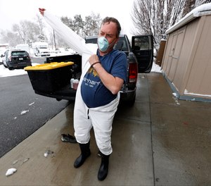 Biohazard cleaner Jamie Milliken suits up to clean a cell in the jail at the Wheat Ridge, Colo., Police Department. What would your facility do if outside cleaning contractors no longer responded during COVID-19?
