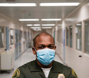In this April 16, 2020, photo Christopher Lumpkin, a custody assistant, poses for a picture at the hospital ward of the Twin Towers jail in Los Angeles.