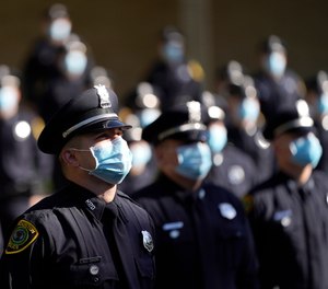 Houston Police cadets wear masks amid the COVID-19 pandemic while taking a class photo during a graduation ceremony at the Houston Police Academy, Friday, May 1, 2020, in Houston.