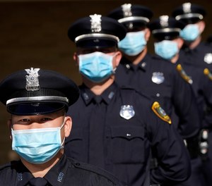 Houston Police cadets wear masks amid the COVID-19 pandemic while taking a class photo during a graduation ceremony at the Houston Police Academy, Friday, May 1, 2020, in Houston.
