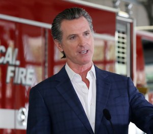 In this May 13, 2020 photo, California Gov. Gavin Newsom discusses the state budget during a news conference at the CAL FIRE/Cameron Park Fire Station. California's state firefighters' union has agreed this week to a 7.5% pay cut for state firefighters after negotiations with Newsom's administration. (AP Photo/Rich Pedroncelli)