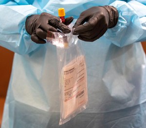 A nurse places a blood specimen in a bag during a COVID-19 antibody test at the Abyssinian Baptist Church, Thursday, May 14, 2020, in the Harlem neighborhood of the Manhattan. New York City Mayor Bill de Blasio announced the launch of free antibody testing for first responders and healthcare personnel across the city, with FDNY and medical examiner's office staff planned to receive the first tests.