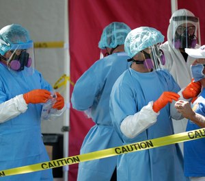 Residents are tested for COVID-19 by the San Antonio Fire Department at a free walk-up test site on Thursday, May 14, 2020. Firefighters across Texas are being asked to help complete the governor's directive to test residents and staff at all nursing homes in the state.