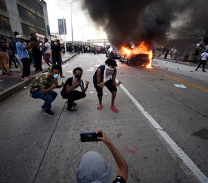 An Atlanta Police Department vehicle burns after George Floyd protests turn violent, Friday, May 29, 2020, in Atlanta. (AP Photo/Mike Stewart)