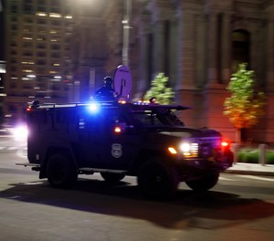 An armored Philadelphia police vehicle drives past City Hall during the Justice for George Floyd Philadelphia Protest, Saturday, May 30, 2020.