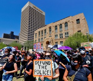 Protesters rally Wednesday, June 3, 2020, in Phoenix, demanding that the Phoenix City Council defund the Phoenix Police Department. (AP Photo/Matt York)