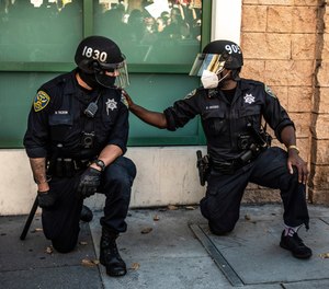 San Francisco police officers kneel at Mission Police Station in San Francisco, California on June 3, 2020 after the death of George Floyd. (Photo/Chris Tuite/ImageSPACE/MediaPunch /IPX