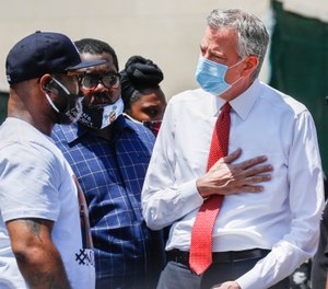 Terrence Floyd, brother of the deceased George Floyd, speaks with New York City Mayor Bill de Blasio, right, during a rally in Brooklyn, Thursday, June 4, 2020(AP Photo/John Minchillo)