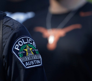 Members of the Austin police department march with members of the University of Texas football team to the State Capitol on Thursday, June 4, 2020, to protest the death of George Floyd.