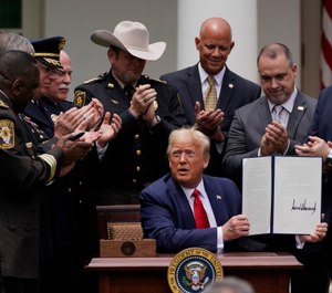 Law enforcement officials applaud after President Donald Trump signed an executive order on police reform, in the Rose Garden of the White House, Tuesday, June 16, 2020, in Washington. (AP Photo/Evan Vucci)