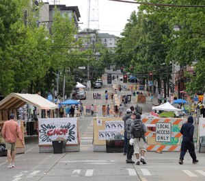 A sign on a barricade reads