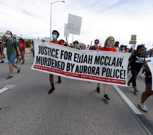 Demonstrators move along Interstate 225 during a rally and march over the death of 23-year-old Elijah McClain Saturday, June 27, 2020, in Aurora, Colo.