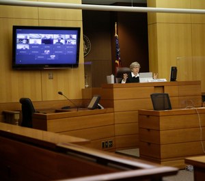 Judge Jane C. Barwick speaks during a bond hearing for former Atlanta police officer Garrett Rolfe who appears on a television screen on Tuesday, June 30, 2020, in Atlanta. (AP Photo/Brynn Anderson, Pool)