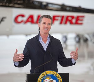 California Gov. Gavin Newsom visits the California Department of Forestry and Fire Protection's McClellan Reload Base in Sacramento, Calif., Thursday, July 9, 2020, to discuss the state's new efforts to protect emergency personnel and evacuees from COVID-19 during wildfires.