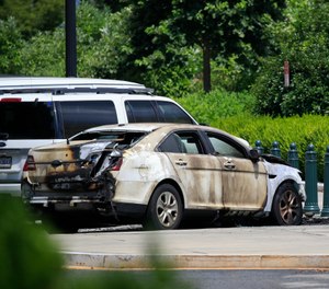 A look at the unmarked police car that was set on fire near the Supreme Court in Washington, Wednesday, July 15, 2020. (AP Photo/Pablo Martinez Monsivais)