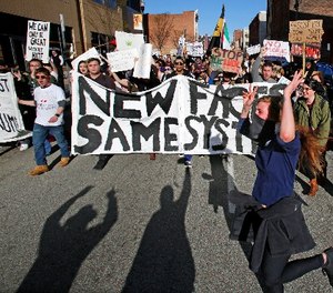 A group of protestors march through downtown Pittsburgh to the David Lawrence Convention Center to protest a visit by Republican presidential candidate Donald Trump in Pittsburgh, Wednesday, April 13, 2016.