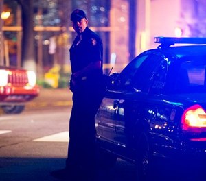 A police officer stands near the scene of an officer-involved shooting, Tuesday, Dec. 1, 2015, in downtown Atlanta.