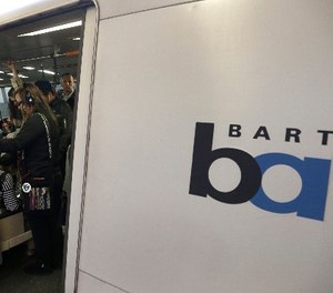 In this Oct. 22, 2013 file photo, Bay Area Rapid Transit passengers wait for a BART train to depart the Fruitvale station in Oakland, Calif.