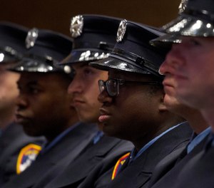 Firefighters participate in a fire department graduation ceremony, Thursday, Dec. 5, 2013 in the Brooklyn borough of New York. (AP Photo/Mark Lennihan)