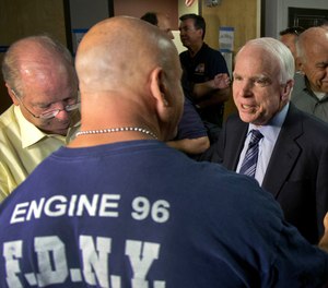 Sen. John McCain speaks with firefighter Thom Yuneman, Friday, July 5, 2013 in Prescott, Ariz.
