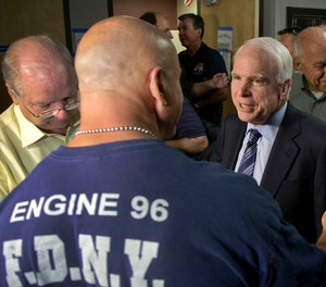 Sen. John McCain speaks with firefighter Thom Yuneman, Friday, July 5, 2013 in Prescott, Ariz.