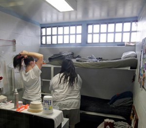 Female inmates interact in their cell at the Timpanogos Women's Correctional Unit during a media tour Thursday, Feb. 26, 2015, at the Utah State Correctional Facility in Draper, Utah.