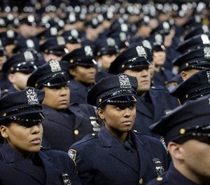 New recruits attend their a New York Police Academy graduation ceremony, Monday Dec. 29, 2014, at Madison Square Garden in New York.