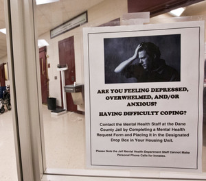 A mental illness poster is seen in the intake room of the Dane County Jail Tuesday, Sept. 16, 2014, in Madison, Wis.
