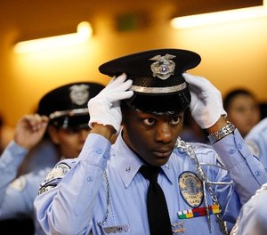 An LAPD Cadet Commander adjusts his hat before the LAPD Cadet Program Graduation.