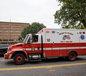 Howard University Hospital in Washington is seen Friday, Oct. 3, 2014, as a District of Columbia ambulance passes. (AP Photo/J. Scott Applewhite)