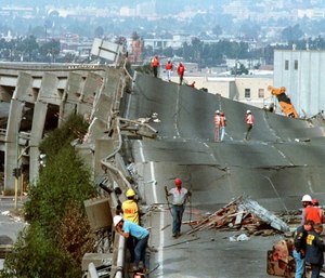 In this Oct. 19, 1989 file photo, workers check the damage to Interstate 880 in Oakland, Calif., after it collapsed during the Loma Prieta earthquake two days earlier.