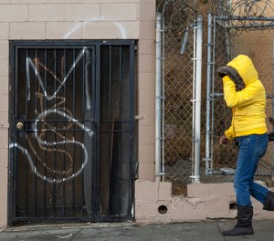 A MS-13, or Mara Salvatrucha graffiti is tagged on a Salvadorean bakery wall in Los Angeles.